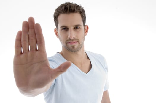 young man showing stop gesture on an isolated white backgound