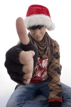 young boy wearing christmas hat showing thumb on an isolated white background
