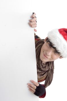 boy wearing christmas hat and holding placard against white background