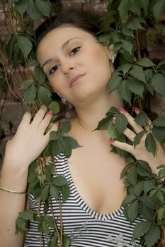 sexy girl posing in front of an old brick wall