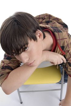 boy sitting on the chair on an isolated background