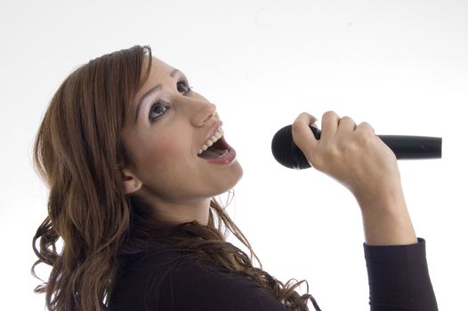 woman singing in microphone on an isolated background