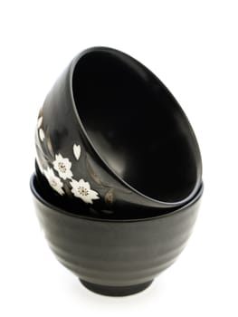 two black china bowls over white background