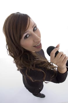 model singing in microphone with white background