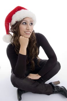 sitting woman wearing christmas hat on an isolated background