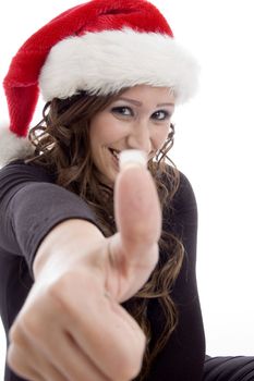 woman wearing christmas hat showing you good luck sign on an isolated background