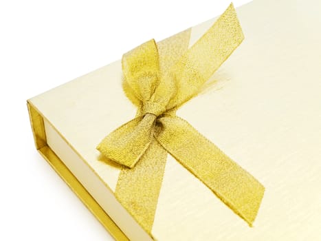 golden gift box with bow over white background