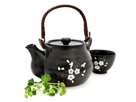 tea set with greens over the white background