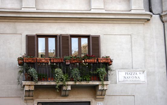 two windows and a balcony in piazza navona from Rome, Italy