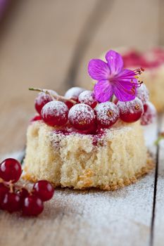 Delicious cupcakes with red currants decorated with a flower
