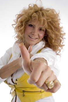smiling woman showing good luck sign against white background