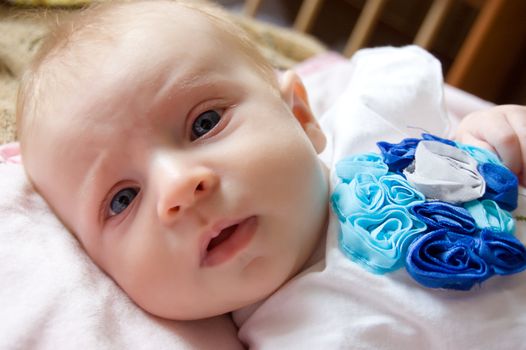 Baby girl closeup lying in its bed