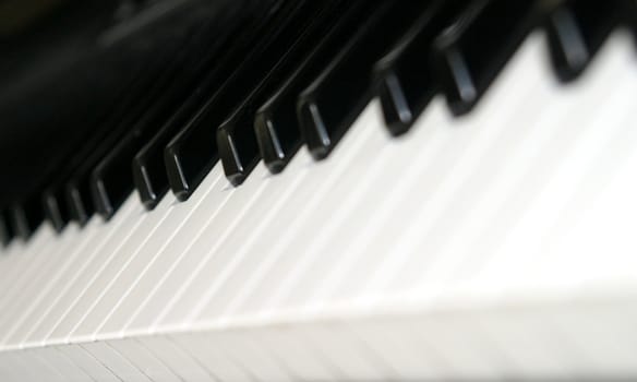 Black and white piano keyboard from an angle.