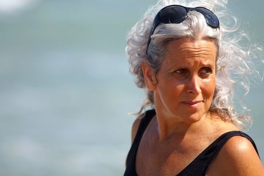 happy elder woman at the beach