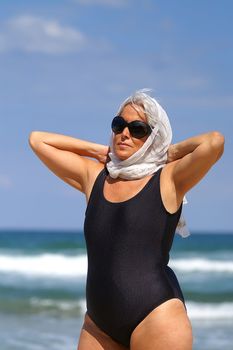 elegant elder woman relaxing at the beach