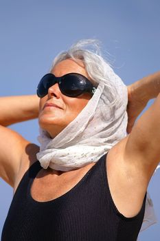 an elegant elder woman at the beach