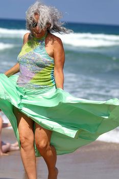 an elder woman having fun at the beach