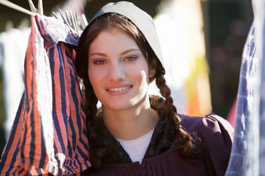 Old fashioned farmgirl hanging the laundry out