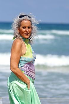 an elder happy woman at the beach