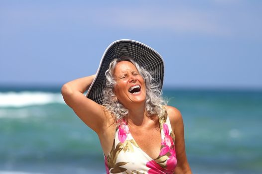 happy elder woman at the beach