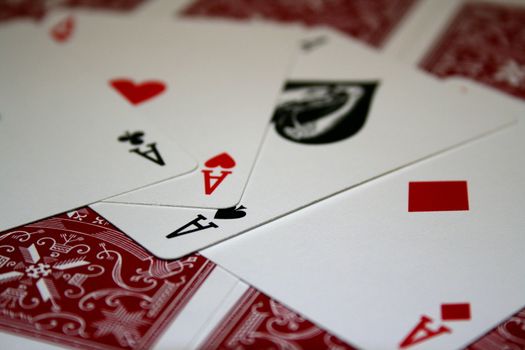 Close up of four aces on a pile of cards.
