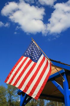 American flag over blue sky on a sunny day.
