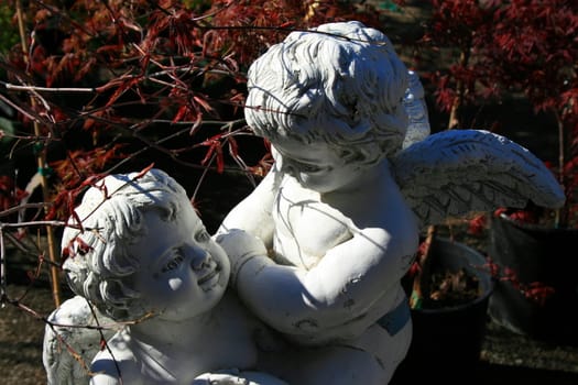 Close up of two antique angel statues.
