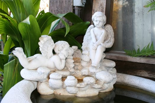 Close up of angel statues on a fountain.
