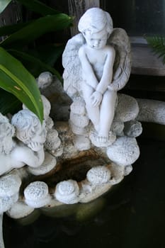 Close up of angel statues on a fountain.
