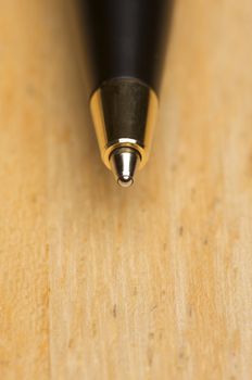 Ball Point Pen Macro on Wood Background with Narrow Depth of Field