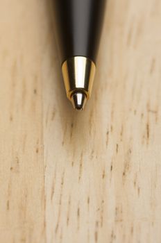 Ball Point Pen Macro on Wood Background with Narrow Depth of Field