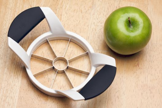 Apple and Slicer on a Wood Background