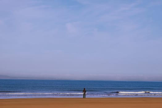 woman on the shoreline lost in thought
