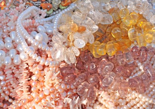 Close up of different gemstone, pearl and coral beads