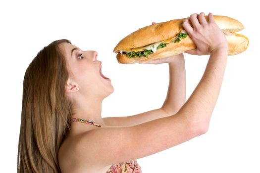 Pretty teen girl eating large sandwich