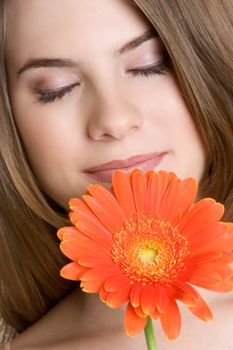 Beautiful girl smelling daisy flower