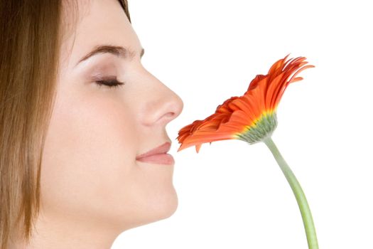 Pretty girl smelling orange flower