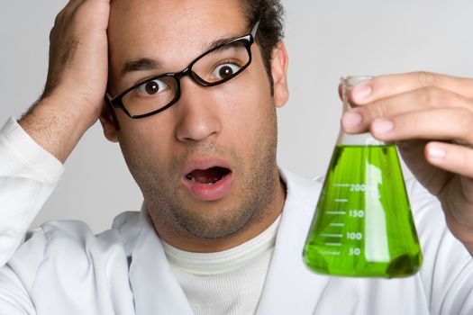 Crazy scientist holding green liquid