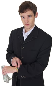 The man in a business suit with a pack of dollars in a hand shows on watch