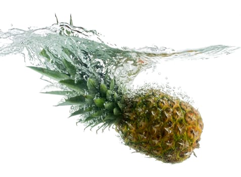 close-up pineapple falling in water with bubbles, isolated on white