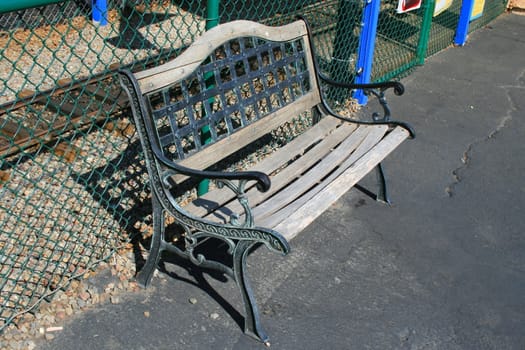 Close up of a bench in a park.
