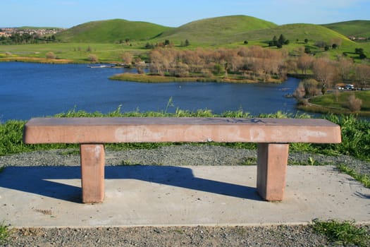 Bench in a park on a top of a mountain.
