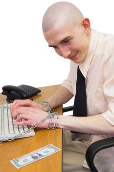 Man riveted by chain to keyboard with longing looks at dollar