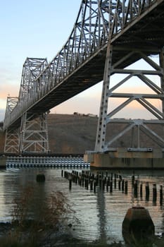 Long modern bridge built over a river.
