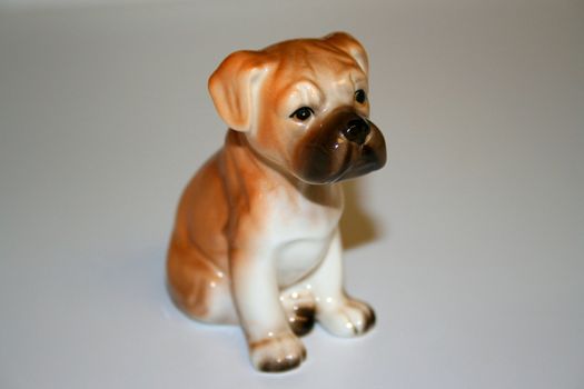 Small boxer puppy figurine close up.