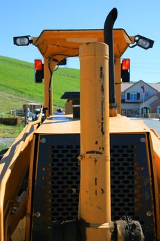 Close up of a bulldozer in a construction sight.
