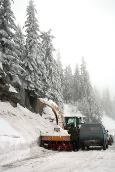 Snowplow in action on rural snow covered road. Winter in Balkans Mountain - Kosovo