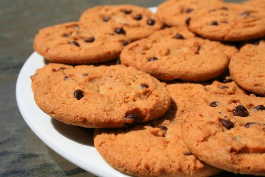 Close up of chocolate chip cookies on a plate.
