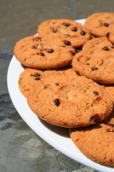 Close up of chocolate chip cookies on a plate.
