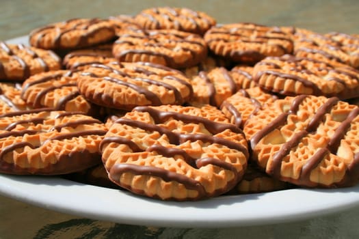 Close up of chocolate striped shortbread cookies on a plate.
